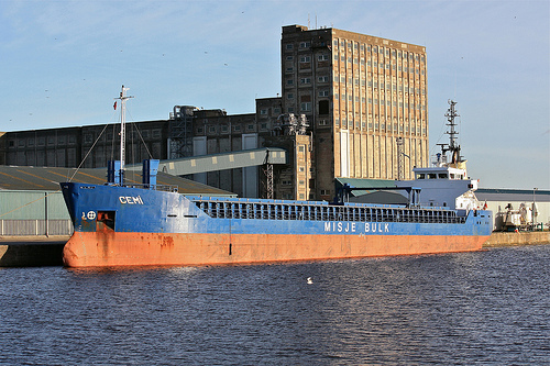 A ship being loaded with grain